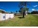 Home exterior with well-manicured yard and partial fencing at 900 Stewart St, Englewood, FL 34223