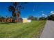 Large yard featuring a small yellow shed at 900 Stewart St, Englewood, FL 34223