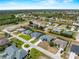 Expansive aerial view showcases a desirable neighborhood with serene water features and neatly landscaped properties at 97 Pine Valley Ln, Rotonda West, FL 33947