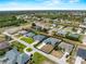Expansive aerial view showcases a desirable neighborhood with serene water features and neatly landscaped properties at 97 Pine Valley Ln, Rotonda West, FL 33947
