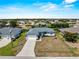 Aerial view of the home with a long driveway and well-maintained surroundings at 97 Pine Valley Ln, Rotonda West, FL 33947