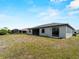 Spacious backyard showcasing the home's exterior and outdoor living potential at 97 Pine Valley Ln, Rotonda West, FL 33947