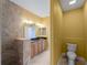 Bright bathroom with granite counters, a tile shower, and a separate toilet area at 97 Pine Valley Ln, Rotonda West, FL 33947