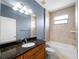Bathroom featuring a combination shower and tub, granite counters, and ample cabinet space at 97 Pine Valley Ln, Rotonda West, FL 33947