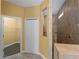 Well-lit bathroom featuring a tiled walk-in shower and a spacious walk-in closet at 97 Pine Valley Ln, Rotonda West, FL 33947