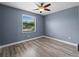 Bedroom with hardwood floors, a ceiling fan and a sunny window with blinds at 97 Pine Valley Ln, Rotonda West, FL 33947