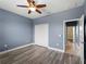 Bedroom featuring gray hardwood floors, a ceiling fan and a closet for storage at 97 Pine Valley Ln, Rotonda West, FL 33947