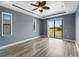 Bedroom with tray ceiling, wood flooring, a ceiling fan and abundant natural light at 97 Pine Valley Ln, Rotonda West, FL 33947
