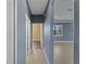 Hallway leading to a bedroom and a living area with neutral paint palette at 97 Pine Valley Ln, Rotonda West, FL 33947