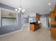 Open-concept kitchen with tile floors, modern cabinets, granite counters, and stainless appliances at 97 Pine Valley Ln, Rotonda West, FL 33947