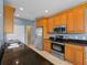 Bright kitchen featuring wood cabinets, stainless appliances, granite countertop, and tile floor at 97 Pine Valley Ln, Rotonda West, FL 33947