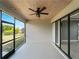 Relaxing screened patio with a stylish ceiling fan and wood plank ceiling at 97 Pine Valley Ln, Rotonda West, FL 33947