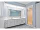 Bathroom boasts a double sink vanity, shower, and ample natural light at 1 Sportsman Way, Rotonda West, FL 33947