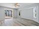 Bright bedroom with wood-look flooring, natural light and sliding glass doors leading to lanai at 1 Sportsman Way, Rotonda West, FL 33947