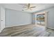 Bedroom with wood-look floors, sliding glass doors to the lanai, and a ceiling fan at 1 Sportsman Way, Rotonda West, FL 33947