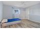 This bedroom features wood floors, a ceiling fan, and a window for lots of light at 1 Sportsman Way, Rotonda West, FL 33947
