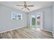 Bedroom with wood-look flooring, ceiling fan, a window, and glass doors with pool view at 1 Sportsman Way, Rotonda West, FL 33947