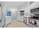 This bright kitchen offers stainless steel appliances, white cabinets, and a large window at 1 Sportsman Way, Rotonda West, FL 33947