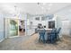 The large, bright kitchen features white cabinets, stainless appliances, and breakfast bar seating at 1 Sportsman Way, Rotonda West, FL 33947