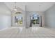 Bright living room with tile flooring, a high ceiling, and arched windows with views of the yard at 1 Sportsman Way, Rotonda West, FL 33947