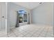Bright living room with tile flooring, a high ceiling, and arched windows with views of the yard at 1 Sportsman Way, Rotonda West, FL 33947