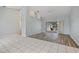 Spacious living room featuring tile and wood flooring that leads to a sliding door and screened-in pool at 1 Sportsman Way, Rotonda West, FL 33947