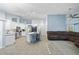 Spacious living room featuring white kitchen island and seating area as well as a grey couch at 1 Sportsman Way, Rotonda West, FL 33947