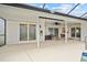 Covered patio with ceiling fan, lounge furniture, and multiple sliding glass doors at 1 Sportsman Way, Rotonda West, FL 33947