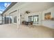 Covered patio with ceiling fan, lounge furniture, and multiple sliding glass doors at 1 Sportsman Way, Rotonda West, FL 33947