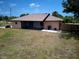 Spacious backyard with patio, screened-in porch, and lawn at 10112 Willmington Blvd, Englewood, FL 34224