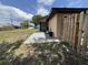 View of the backyard with a clean cement patio and adjacent fence at 10112 Willmington Blvd, Englewood, FL 34224