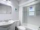 Clean bathroom with tub, white shower curtain and modern fixtures at 10112 Willmington Blvd, Englewood, FL 34224