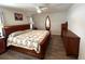 Bedroom with ceiling fan, wood furniture and surf board mirror at 10112 Willmington Blvd, Englewood, FL 34224