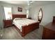 Bedroom with ceiling fan, wood furniture and surf board mirror at 10112 Willmington Blvd, Englewood, FL 34224