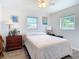 Comfortable bedroom with ample natural light, ceiling fan, and clean design at 10112 Willmington Blvd, Englewood, FL 34224