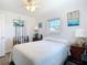 Bright bedroom with white walls and wooden fishing rod decor at 10112 Willmington Blvd, Englewood, FL 34224