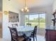 Bright dining area with a beautiful view of the neighborhood and a decorative chandelier at 10112 Willmington Blvd, Englewood, FL 34224