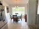 View of a dining room with a round wooden table with 4 chairs and a window at 10112 Willmington Blvd, Englewood, FL 34224