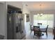 Inviting dining area adjacent to the kitchen features a window overlooking the lush backyard and a modern chandelier at 10112 Willmington Blvd, Englewood, FL 34224