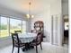 Bright dining room featuring a large window, tile floors, a classic china cabinet, and ample natural light at 10112 Willmington Blvd, Englewood, FL 34224