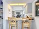 Bright kitchen with light countertops, island seating, and stainless steel appliances at 10112 Willmington Blvd, Englewood, FL 34224