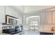 Modern kitchen with stainless steel appliances, granite countertops, white cabinets, and a window with natural light at 10112 Willmington Blvd, Englewood, FL 34224