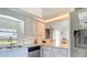 Stylish kitchen featuring white cabinets, granite countertops, modern appliances, and an adjacent dining area with ample seating at 10112 Willmington Blvd, Englewood, FL 34224