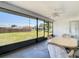 Relaxing screened patio with a ceiling fan and view of the backyard at 10112 Willmington Blvd, Englewood, FL 34224