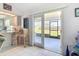 Open sun room featuring tile flooring and access to the outdoor space with a kitchen eating bar at 10112 Willmington Blvd, Englewood, FL 34224