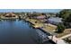 Waterfront home with private boat dock and lift on a sunny day at 110 Colonial Sw St, Port Charlotte, FL 33952
