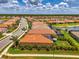 Great aerial view of a well-maintained home in a scenic lakeside community with lush lawns at 11819 Sistine Ln, Venice, FL 34293