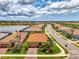 Community aerial view with lovely homes, landscaping, and a scenic lake with fountain at 11819 Sistine Ln, Venice, FL 34293