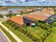 Expansive aerial view of a well-maintained home, showcasing lush landscaping and community lake at 11819 Sistine Ln, Venice, FL 34293