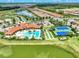 Comprehensive aerial view featuring the community amenities, including the pool, courts, and playground at 11819 Sistine Ln, Venice, FL 34293